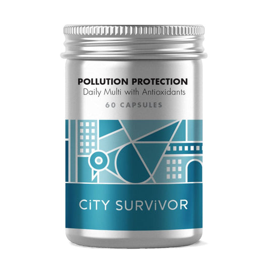 A metal screw top pot with teal abstract cityscape design featuring a pigeon logo. Label text reads City Survivor Pollution Protection Daily Multi with Antioxidants - 60 capsules